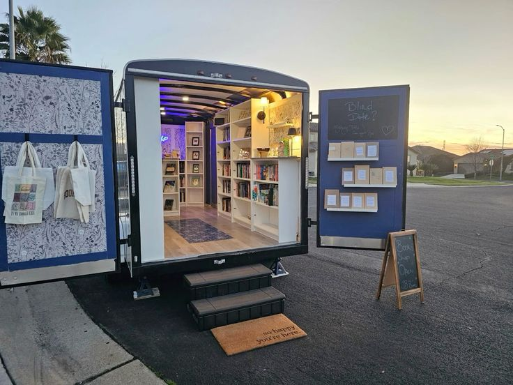 The Mini Book Truck parked on a neighborhood street with kids browsing